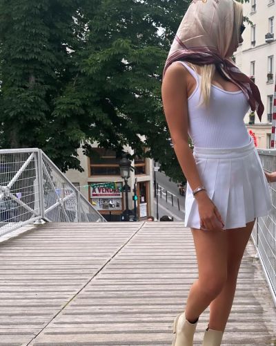 Spanish blonde wearing and a fur around her neck white lingerie